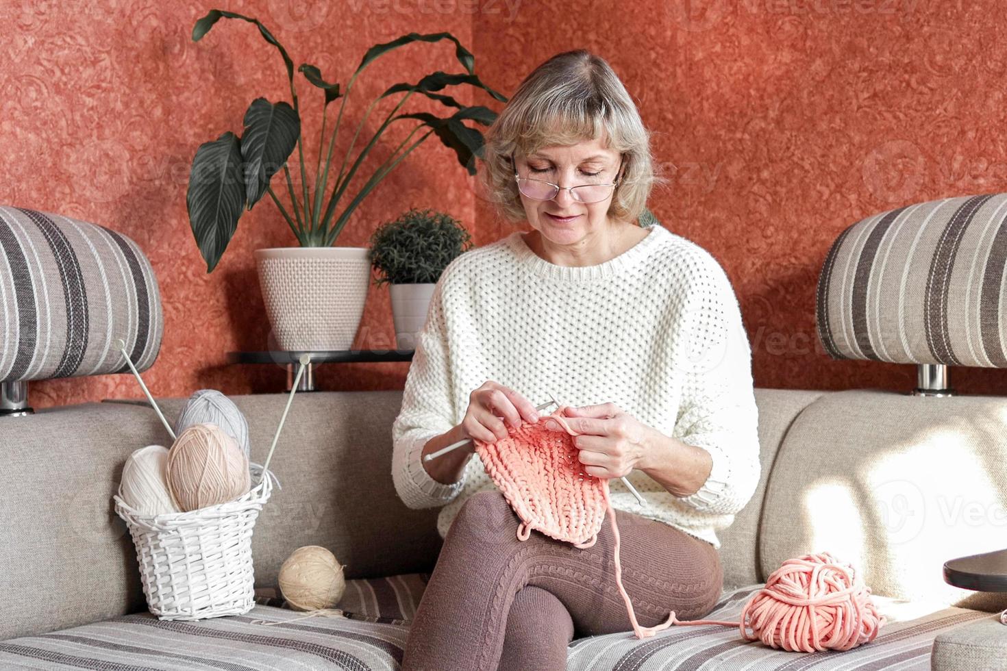 Happy and relaxed female people enjoying time indoor on the sofa. Knit job photo