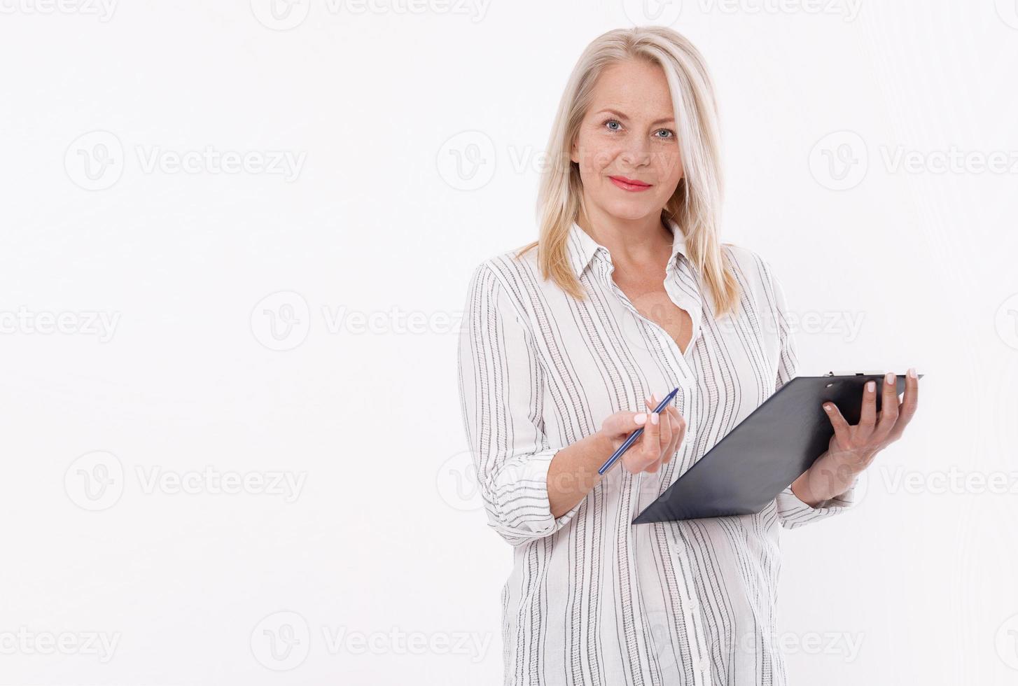Business woman holds a pen and a folder with files isolated on white background photo