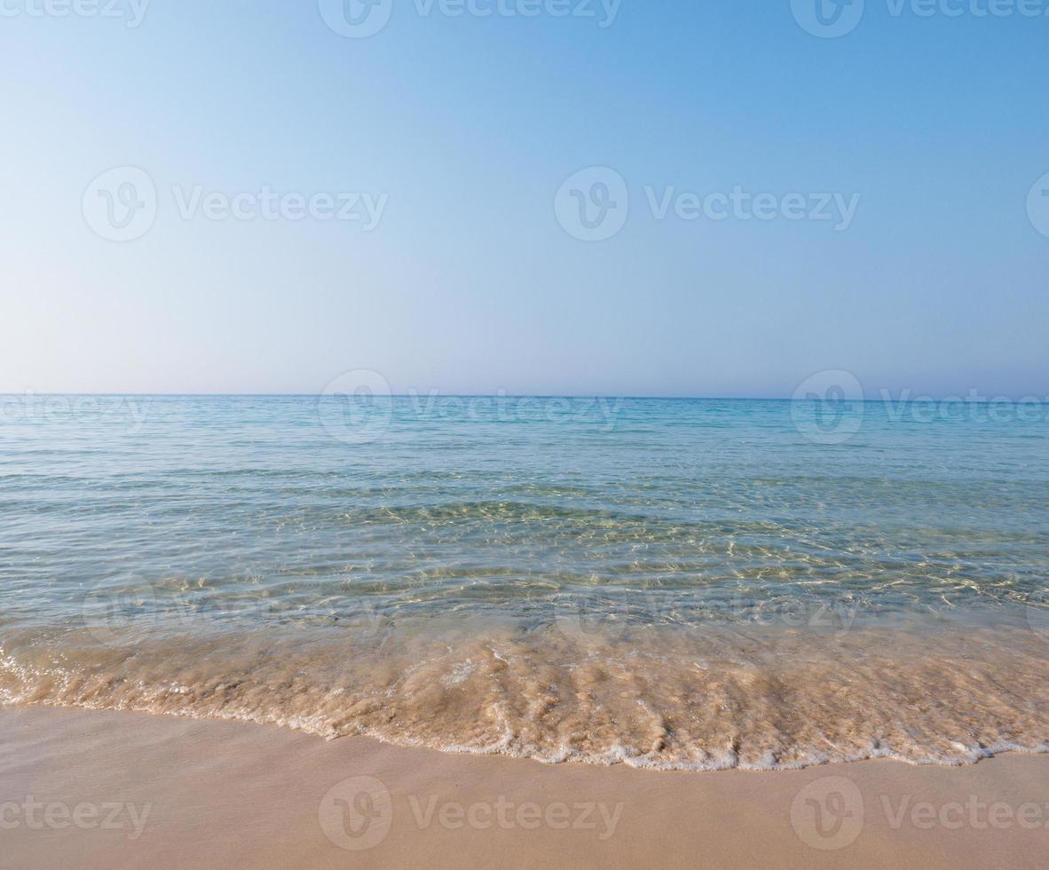 Soft Wave Of Blue Ocean On Sandy Beach. Tropical beach. Summer background.Selective focus. photo