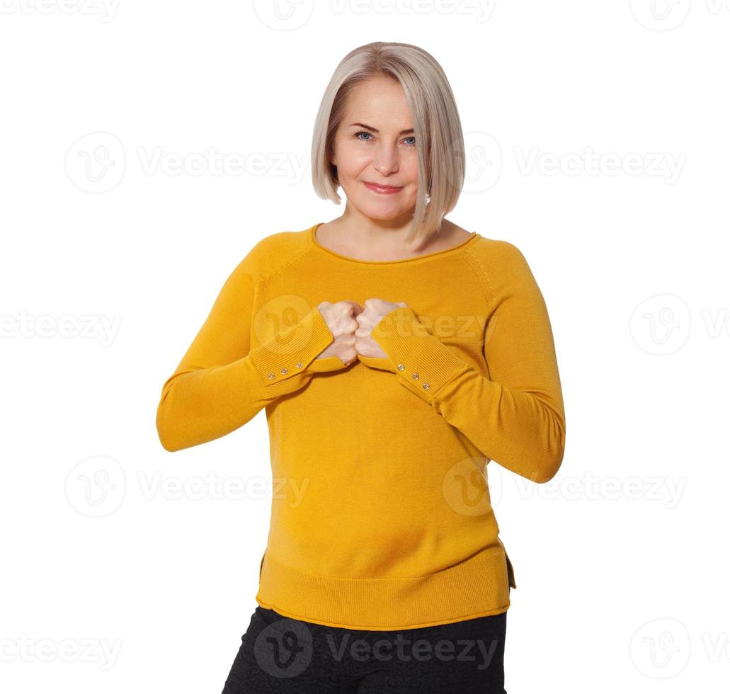 Attractive Middle Aged Woman expresses anger and conflict. Woman shows clenched fists and hatred, clenched teeth, discontent and stress. Woman in bright clothes posing in studio on white background photo