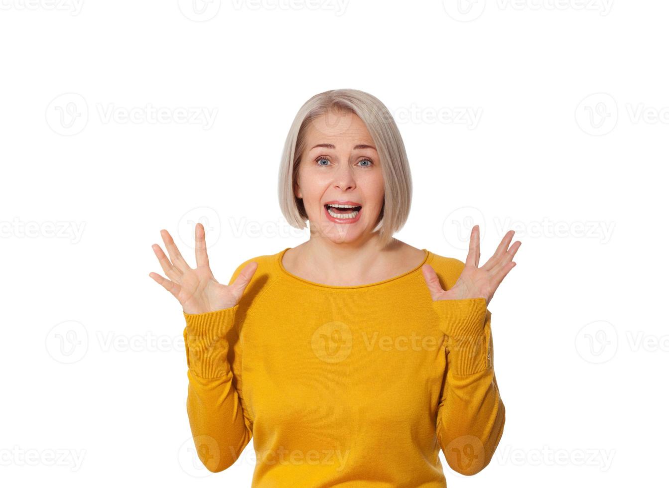 Attractive Middle Aged Woman expresses fear and horror, panic and cry, hysterics and problem, surprise and fright. Woman in bright clothes posing in studio on white background photo