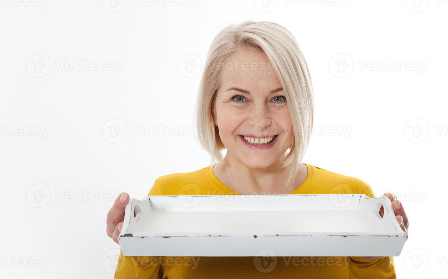 Kitchen woman gives empty tray for your advertising products isolated on white background. Mock up for use photo
