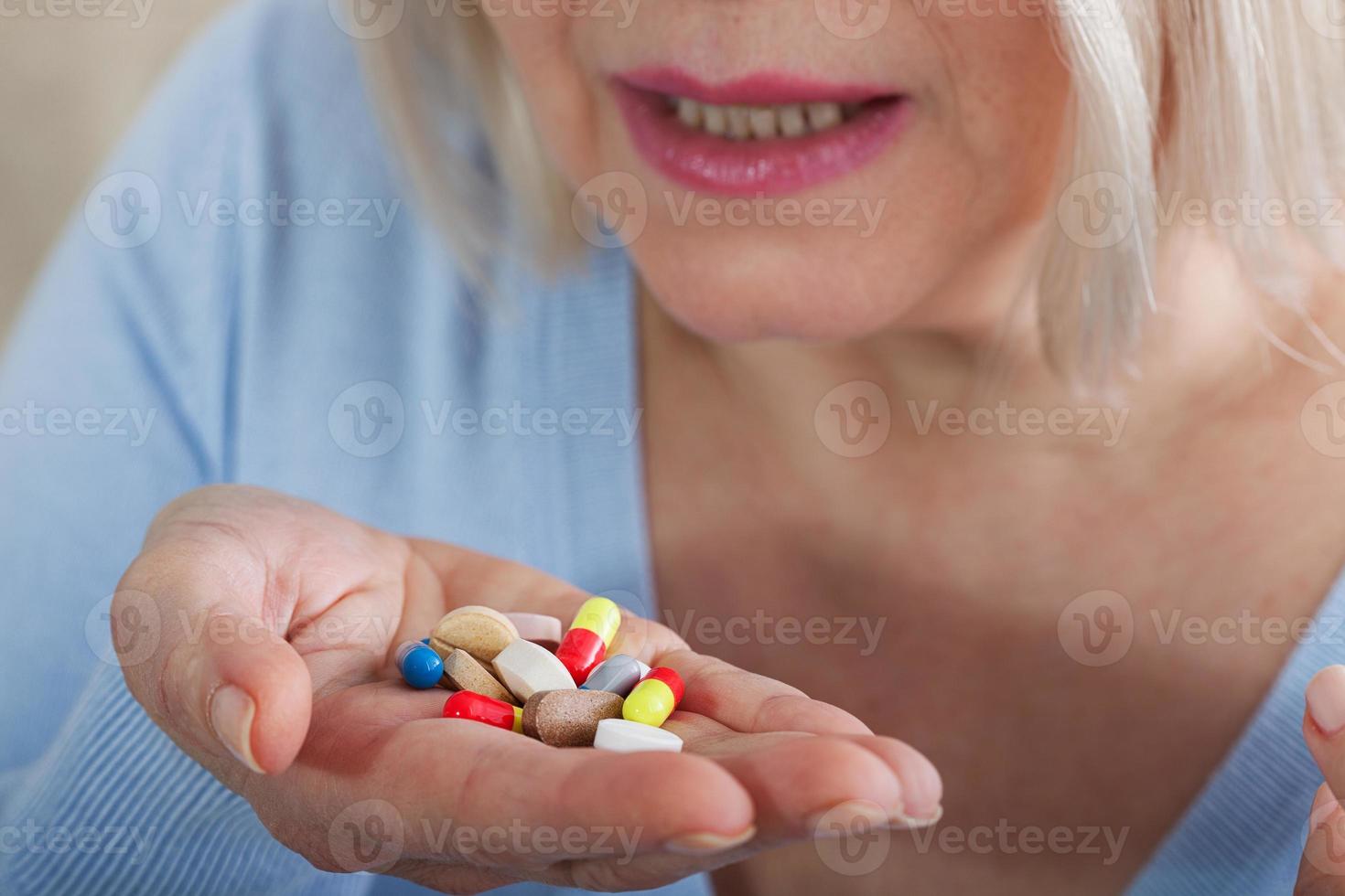 Many pills in woman hands. closeup on white background, macro selective focus. photo