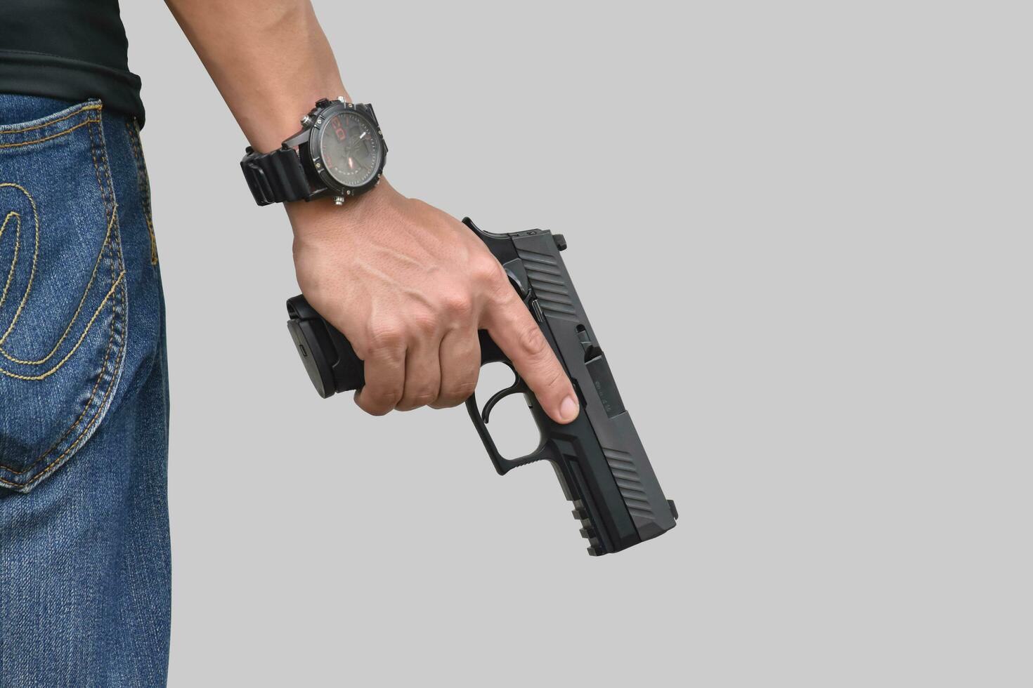 Isolated 9mm pistol gun holding in right hand of gun shooter with clipping paths. photo