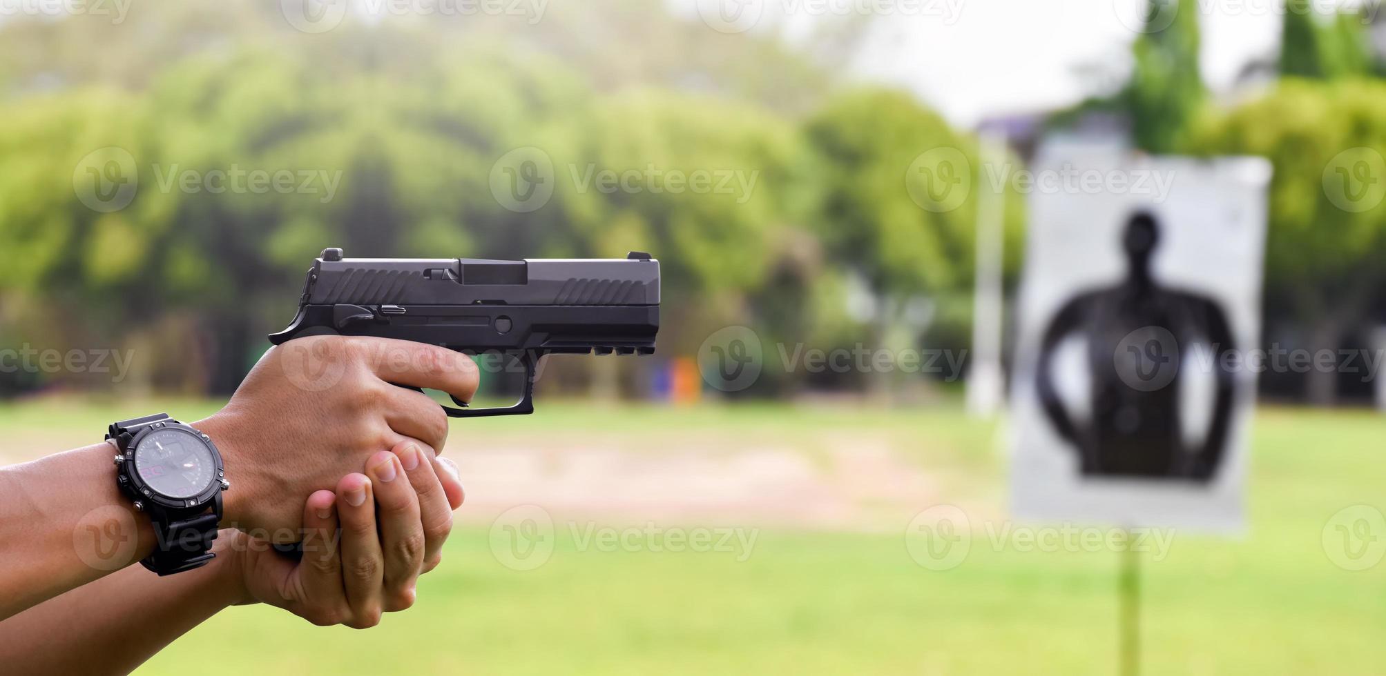 9mm automatic pistol holding in right hand of shooter, concept for security, robbery, gangster, bodyguard around the world. selective focus on pistol. photo