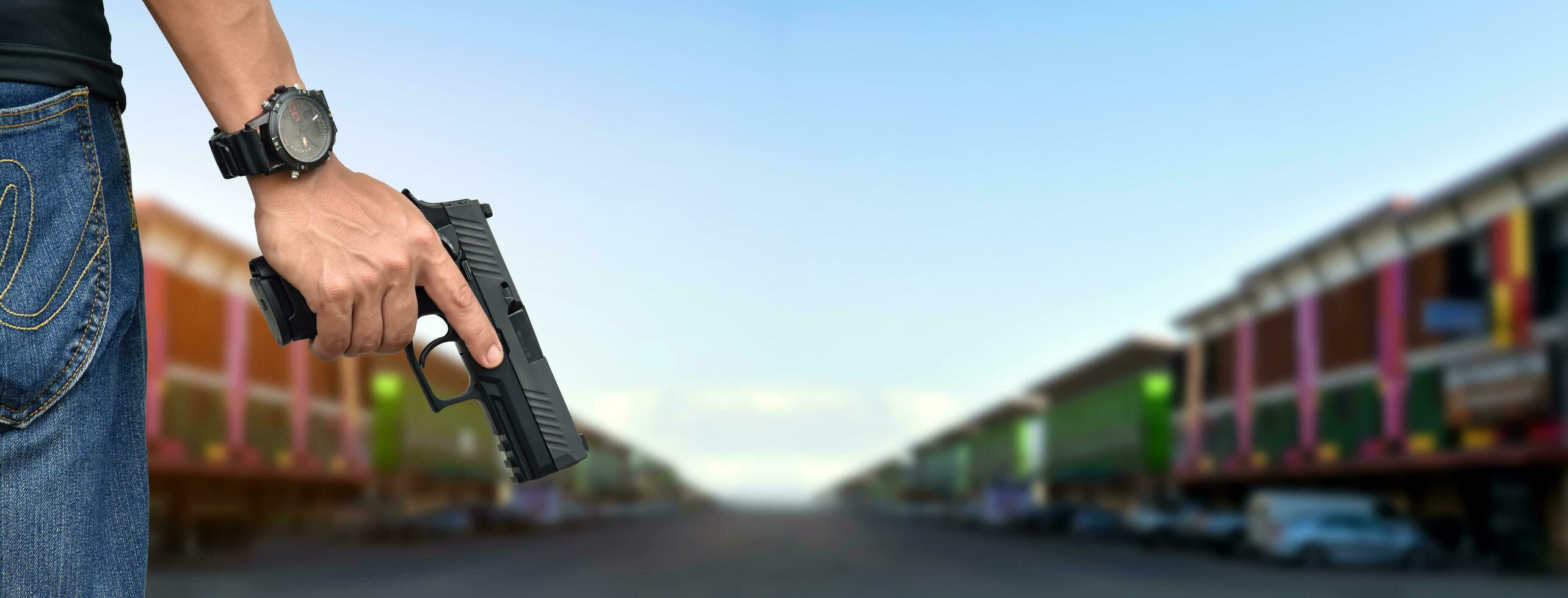 9mm automatic pistol holding in right hand of shooter, concept for security, robbery, gangster, bodyguard around the world. selective focus on pistol. photo