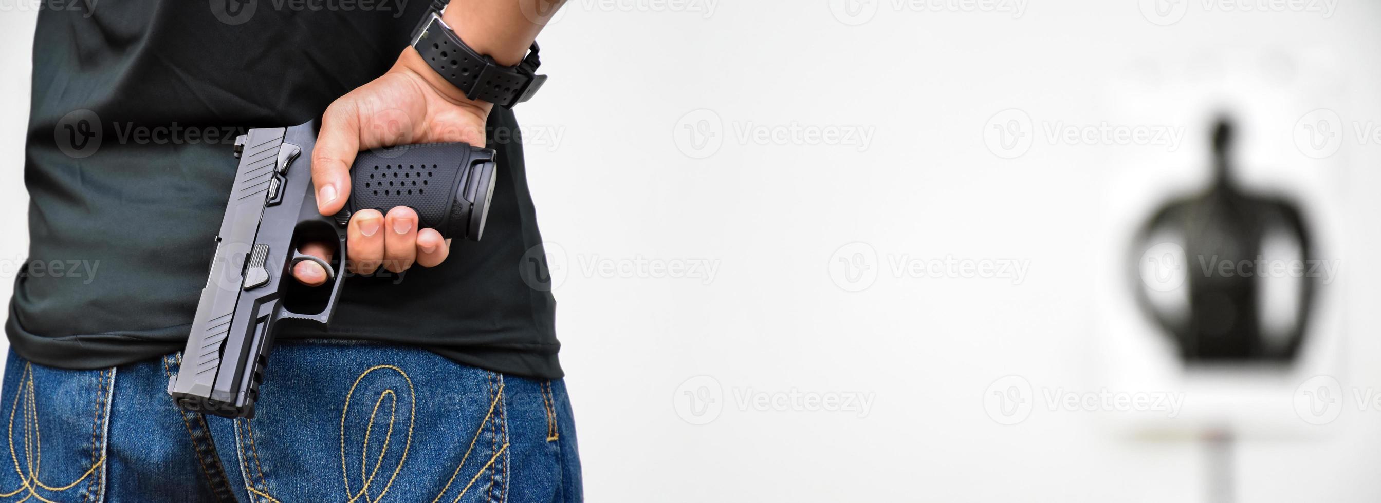 9mm automatic pistol holding in right hand of shooter, concept for security, robbery, gangster, bodyguard around the world. selective focus on pistol. photo