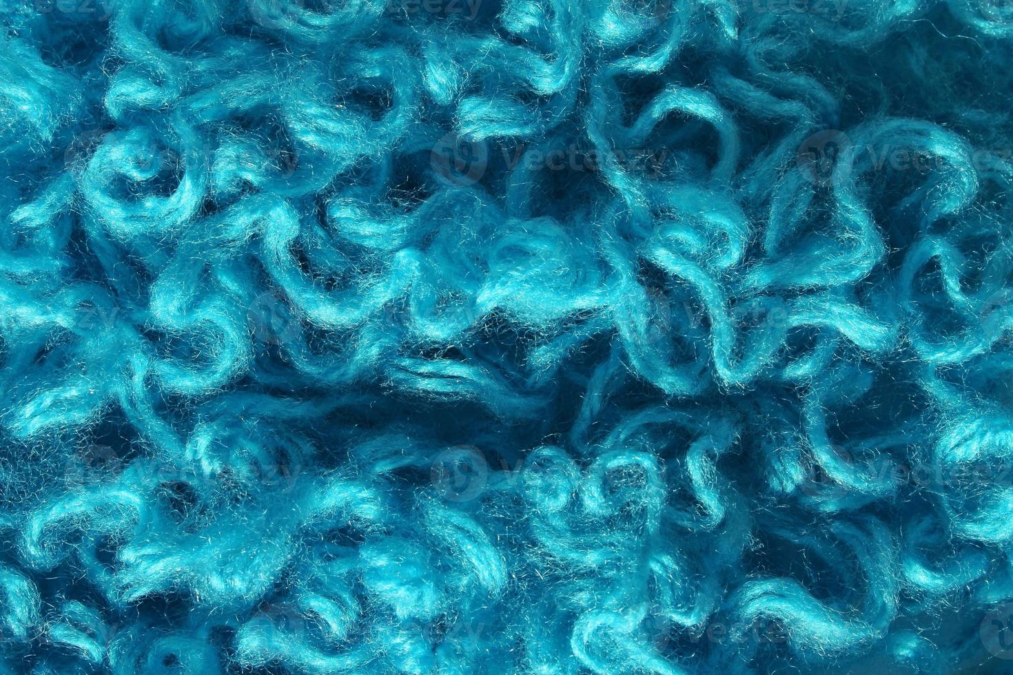 Close-up of colourful merino wool deep blue striped background. Abstract handmade craft knitting yarn textured pattern flatlay. Holiday christmas concept. Idea for felting, needlework, hobby. Mock up photo