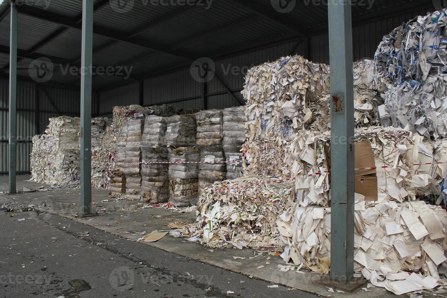 Wastepaper compact texture pile for recycling on sorting plant. Technology of reuse materials. Stack of shredded paper. Save the planet ecology concept. Industry of reduced pollution factory. Close-up photo