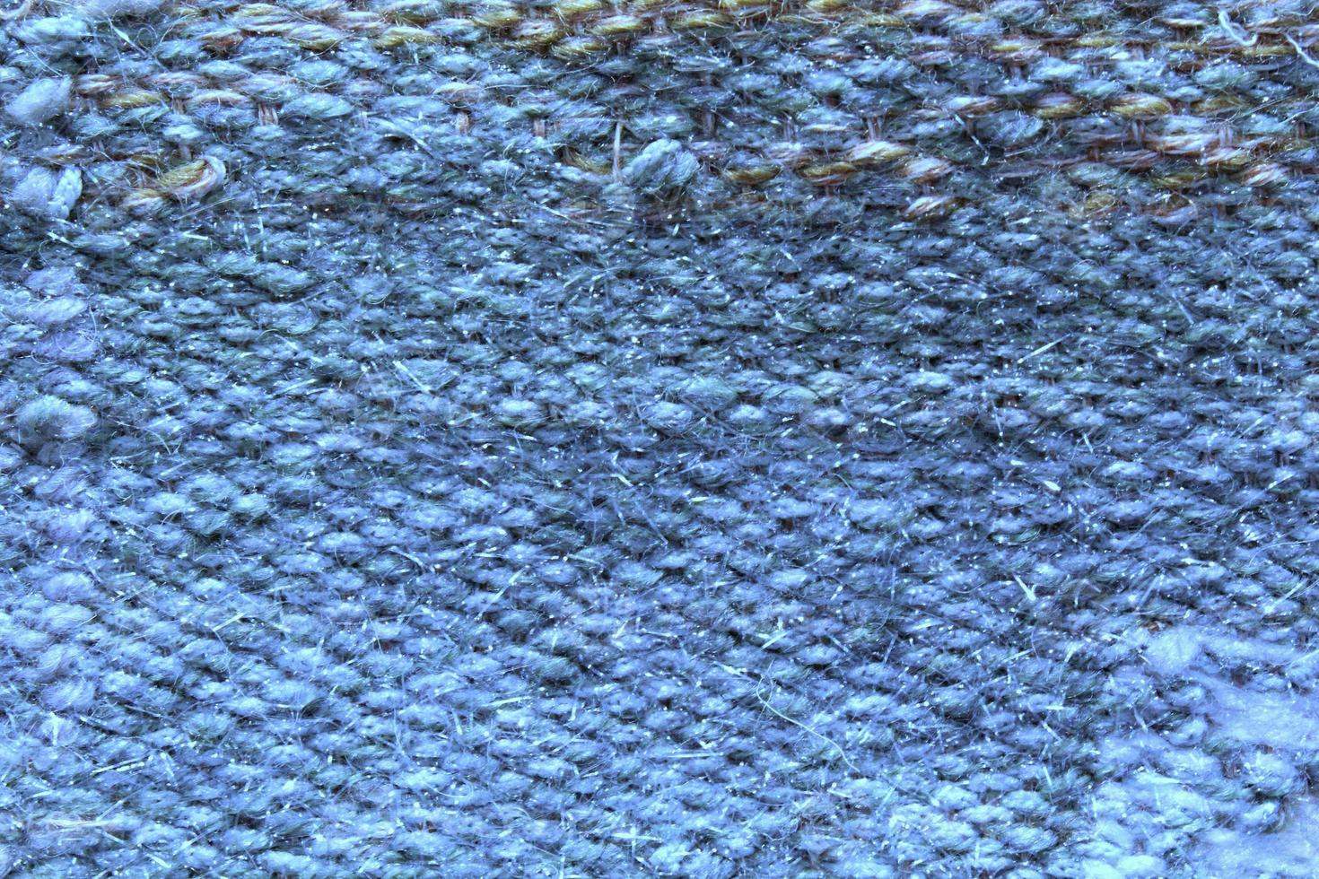 Woven blue wool fabric texture. Hand knitted textile canvas background. Patchwork carpet backdrop. Factory material threads. Abstract design. Close-up, mockup, top view photo