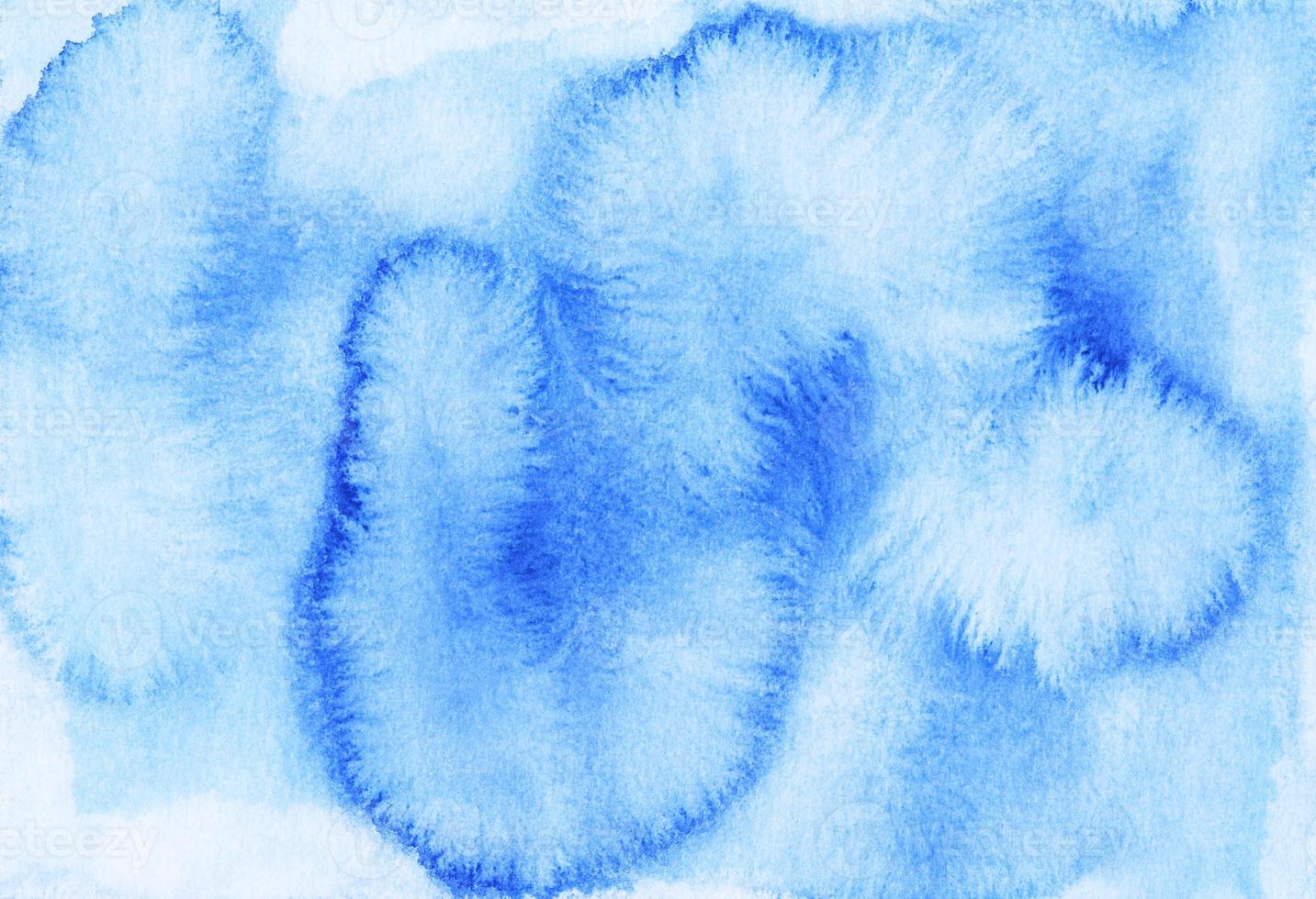 Watercolor light blue stains on paper background. Hand painted backdrop. photo