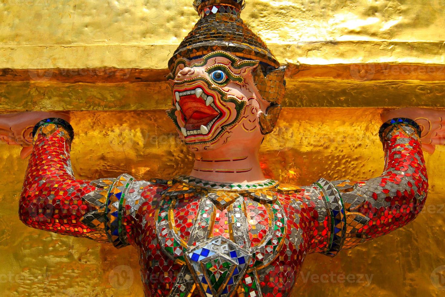Close up Ramayana pink Giant or monky Ssculpture with yellow or golden background at Thai temple, Bangkok, Thailand. Beautiful art design, exterior, Religion and Object concept. photo