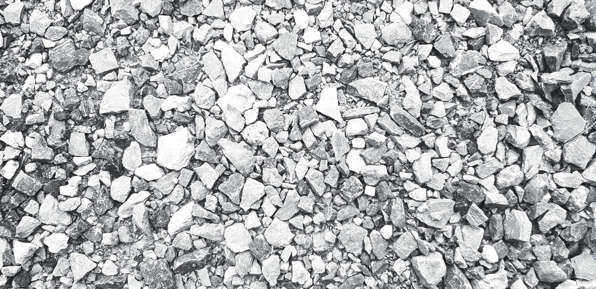 Pattern of small gravel, rock or stone on the ground for background in black and white tone. Hard material, Art or Textured wallpaper and Group of object in monochrome style photo