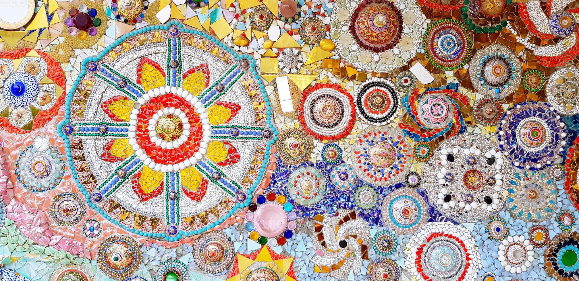Beautiful mosaic of art design wall for background at Wat Pha Sorn Kaew temple, Thailand. Decoration colorful mosaic, gravel, small stone and broken tile for wallpaper. Abstract and Artwork concept photo