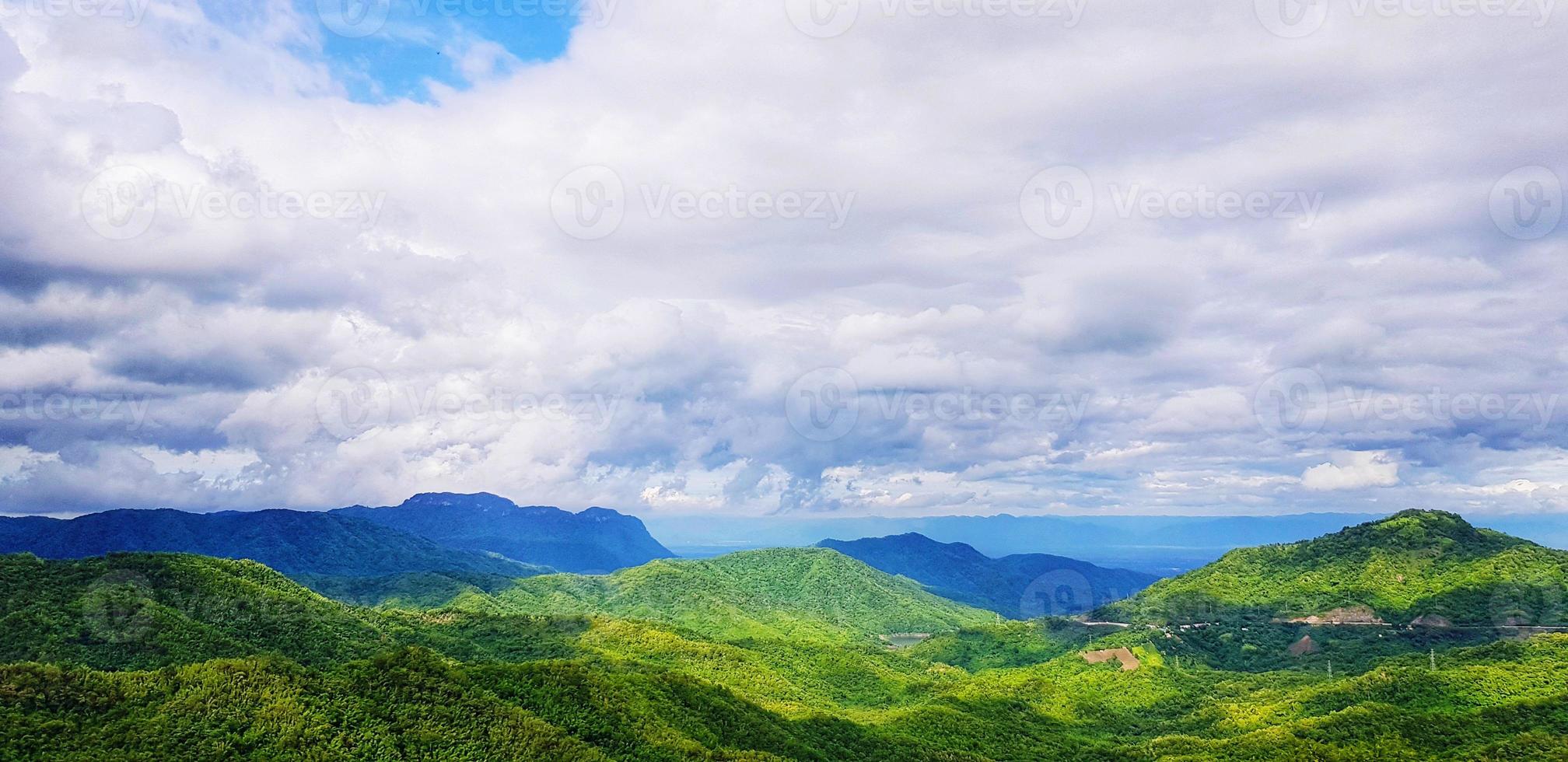 Beautiful landscape of mountain. Green forest or jungle with mountain heel and cloud sky. Beauty of nature and Natural wallpaper concept photo