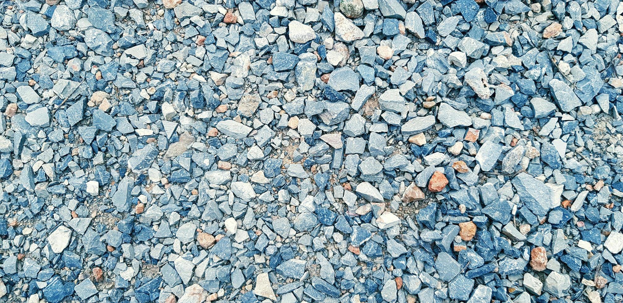 Pattern of small gravel, rock or stone on the ground for background in blue vintage color tone. Hard material, Art or Textured wallpaper and Group of object concept photo