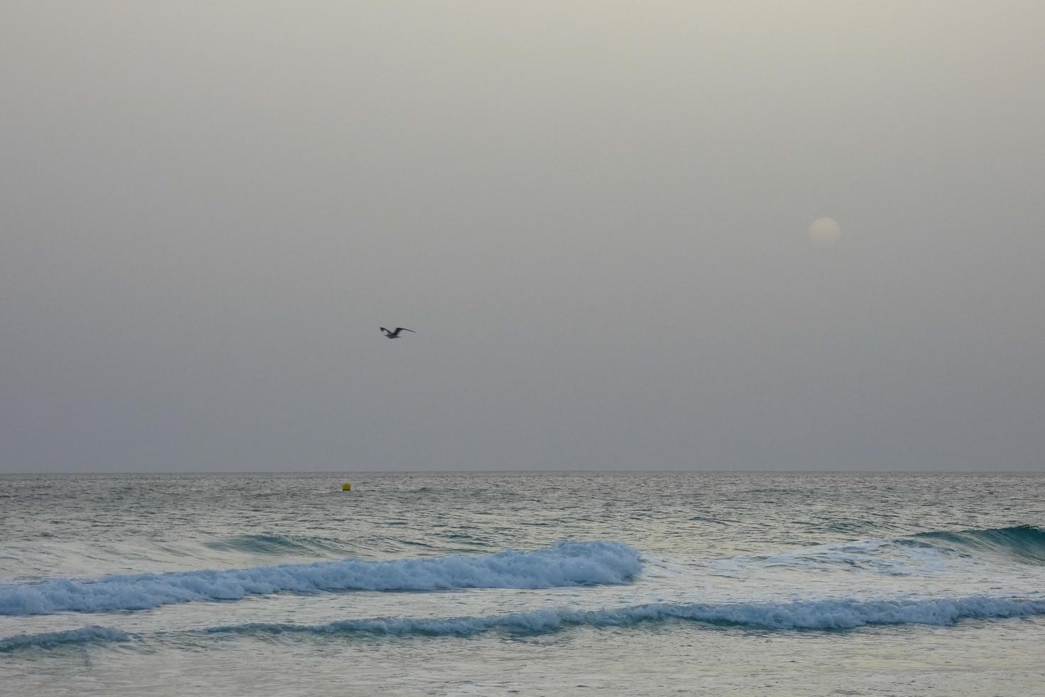 lonely, uncrowded beach with calm sea and small waves photo