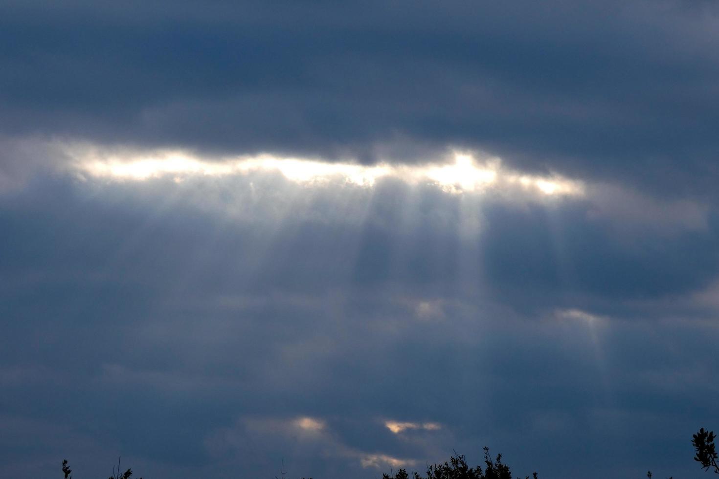 sky between open with rays of sunlight coming through the clouds photo