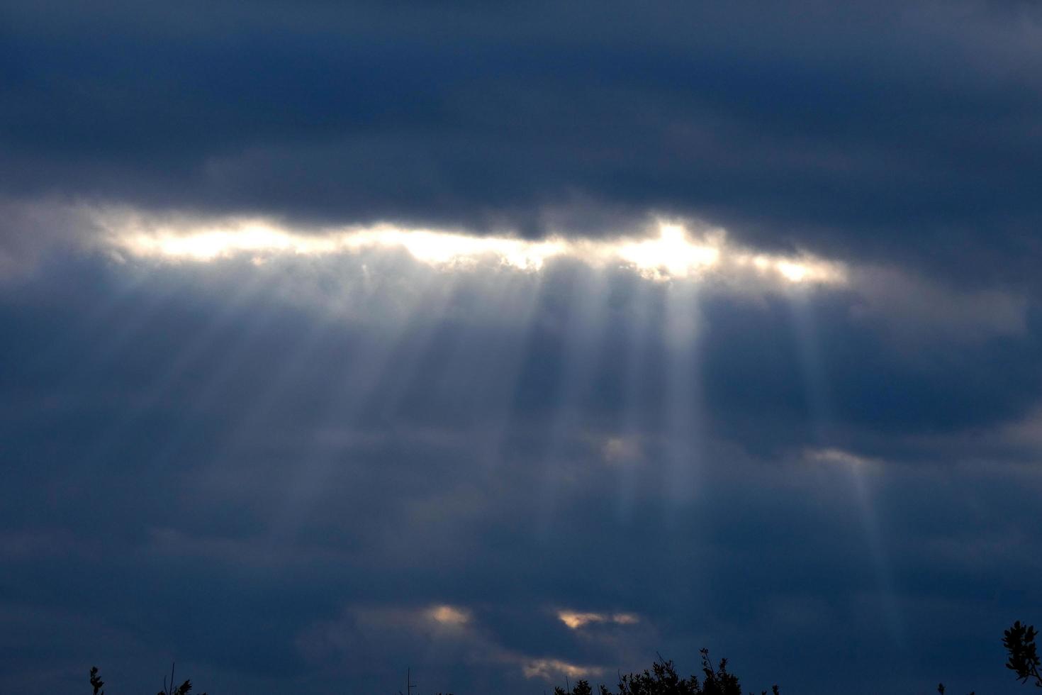 cielo Entre abierto con rayos de luz de sol viniendo mediante el nubes foto