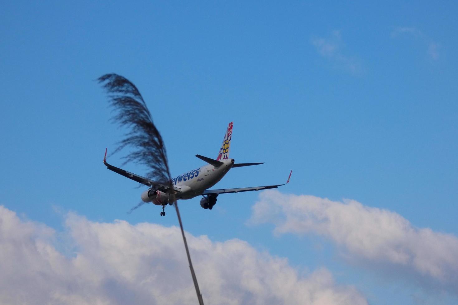 Commercial aircraft overflying the sky and arriving at airport photo