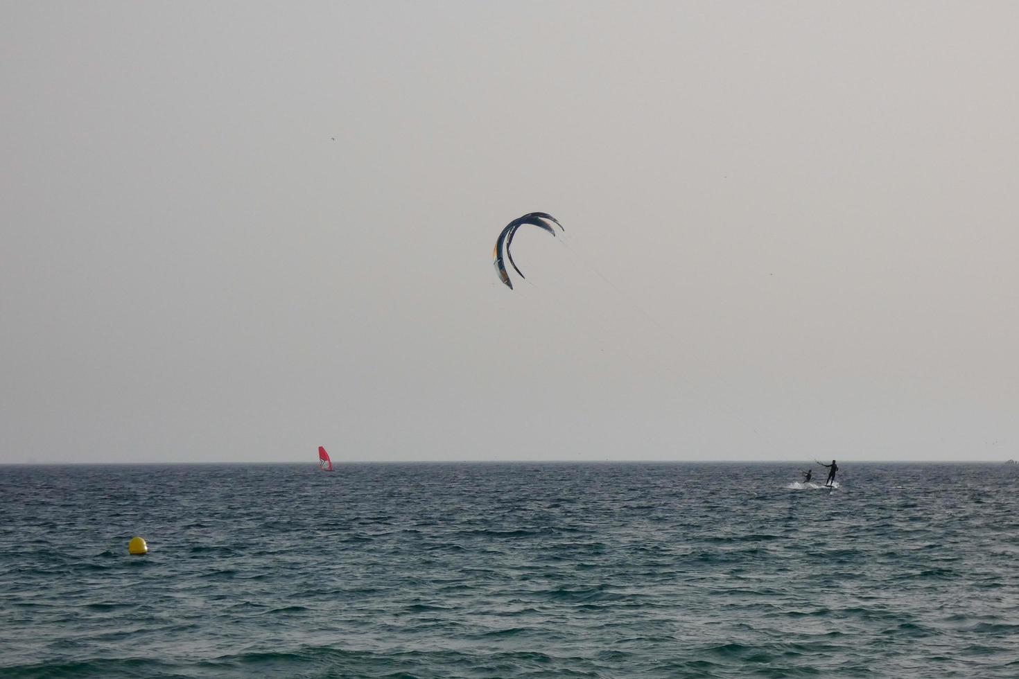 windsurfing, kitesurfing, water and wind sports powered by sails or kites photo