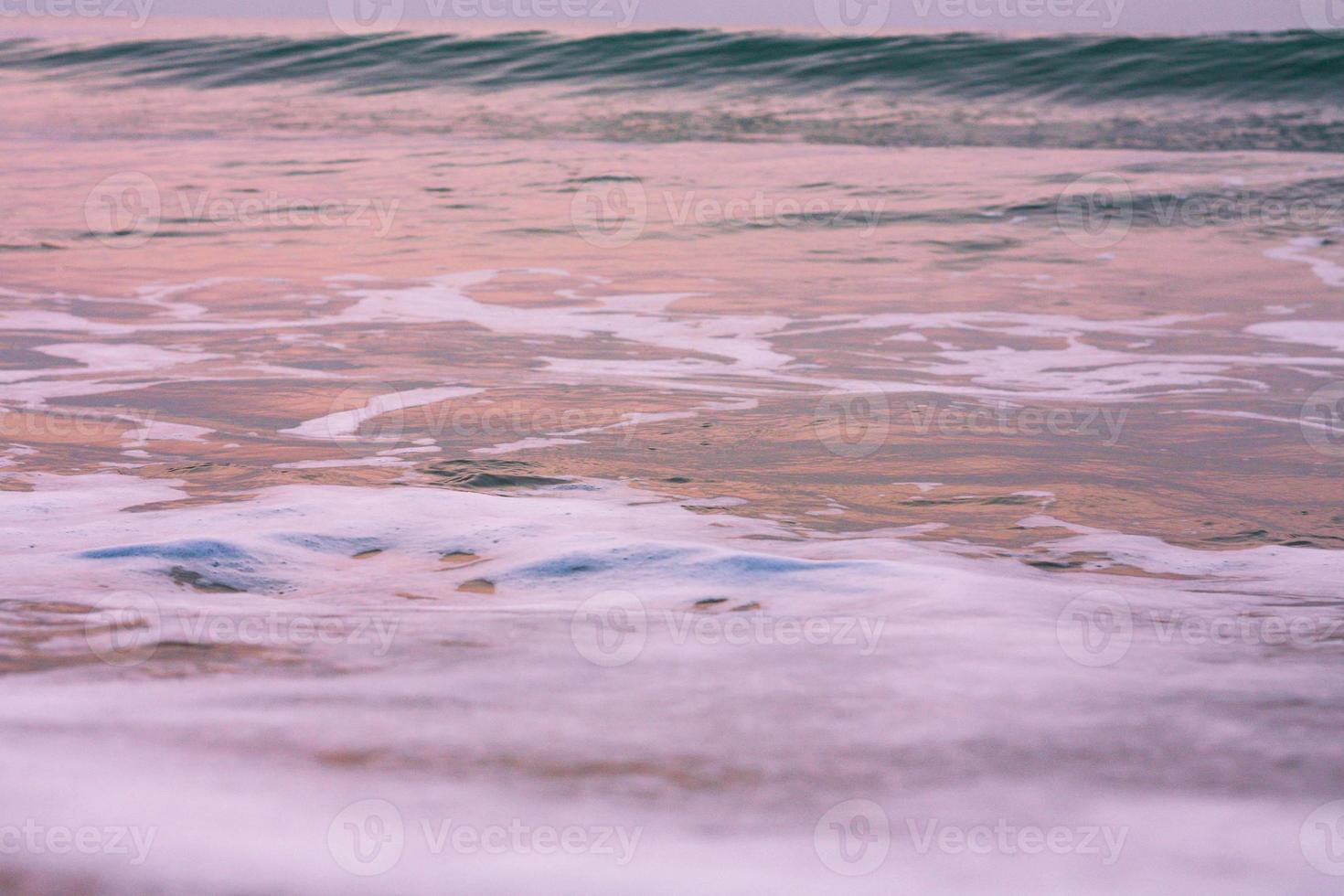 Bubbles on golden beach with ocean water in the morning at Thailand beaches. photo