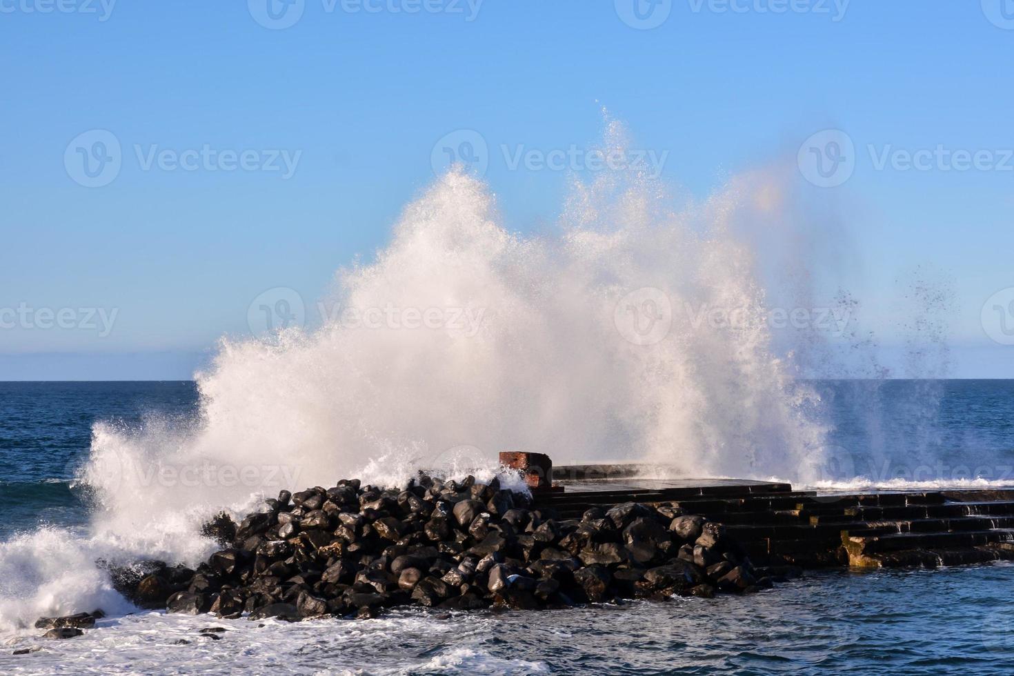 Huge waves crashing on the shore photo