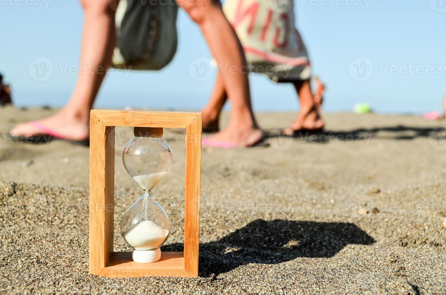 Hourglass in the sand photo