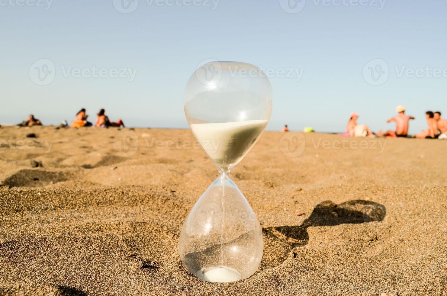 Hourglass on the sand photo