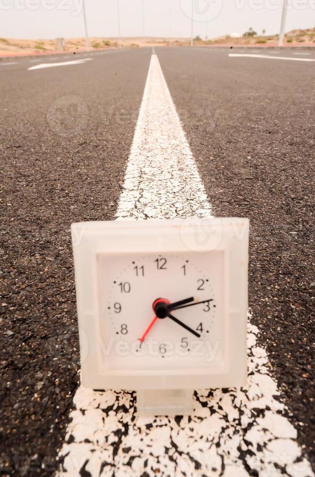 Clock on the road photo