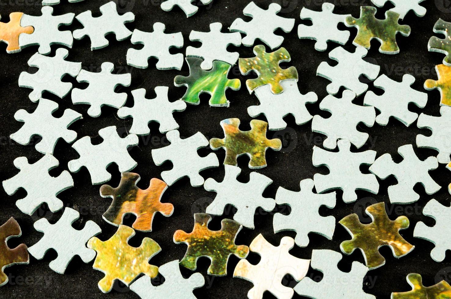 Puzzle pieces on dark background photo