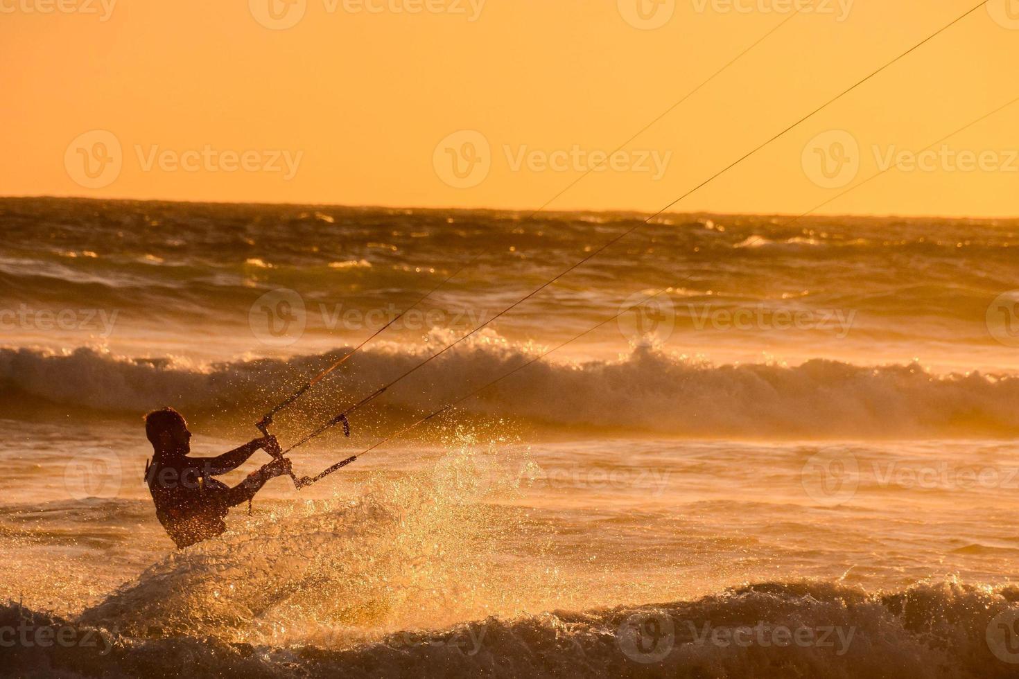 Kite surfer at sunset photo
