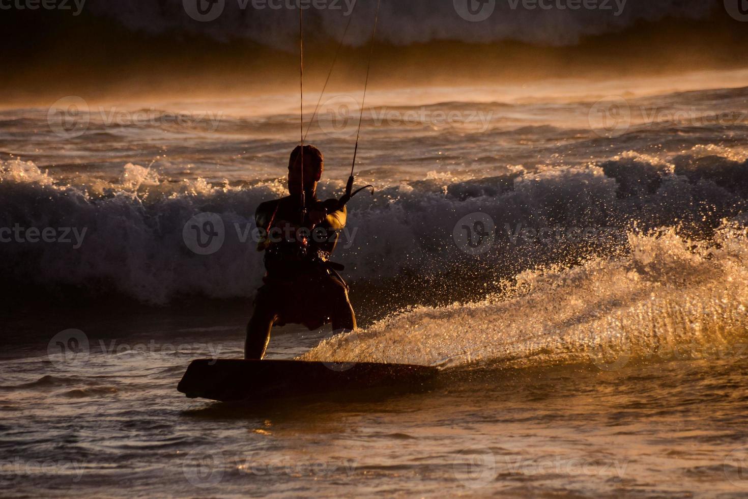 Kite surfer at sunset photo