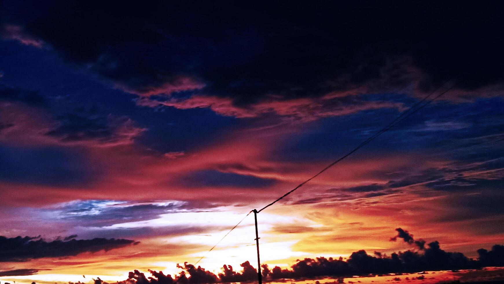 the background of orange twilight clouds at sunset photo