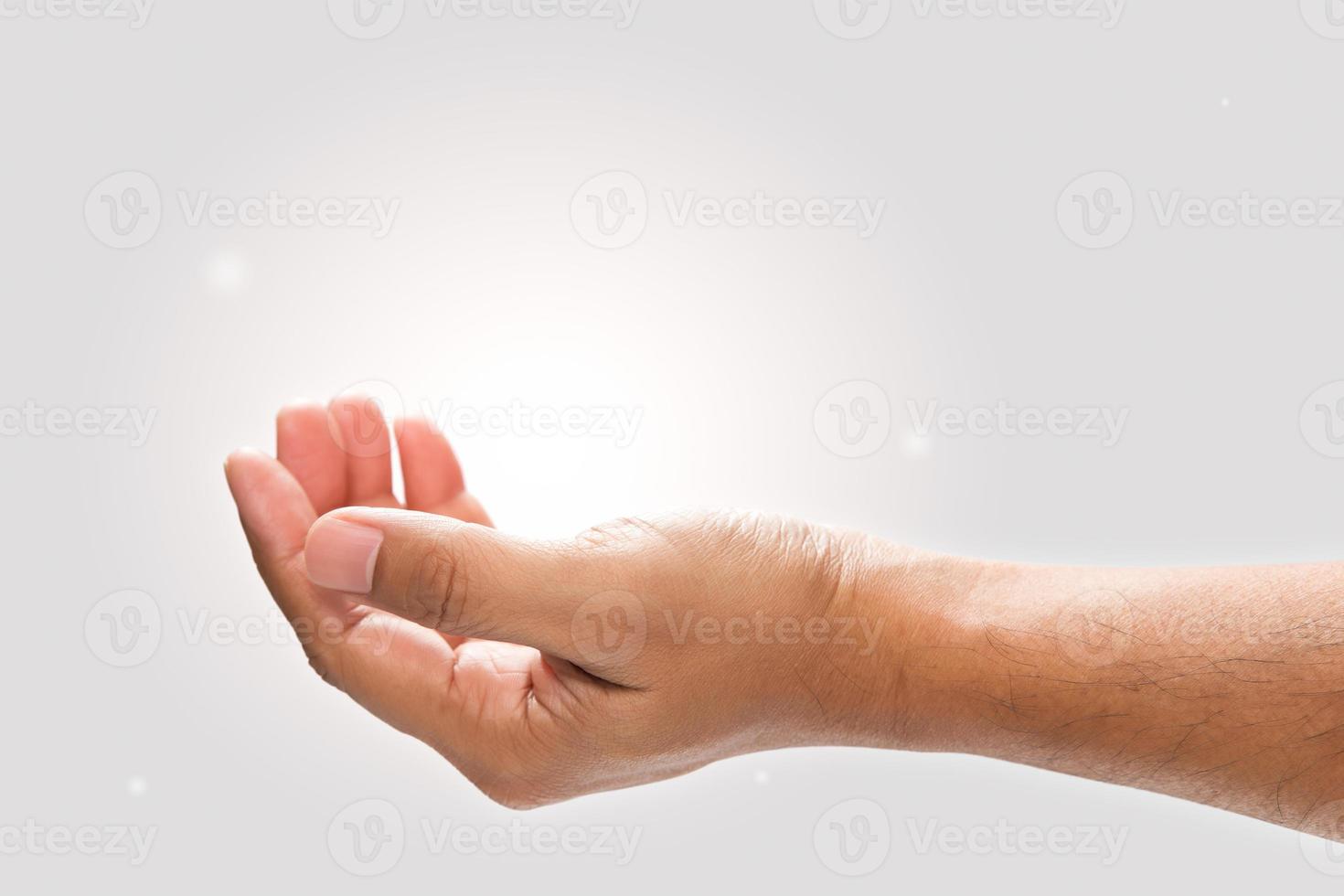 Male hand to hold something on a gray background. photo