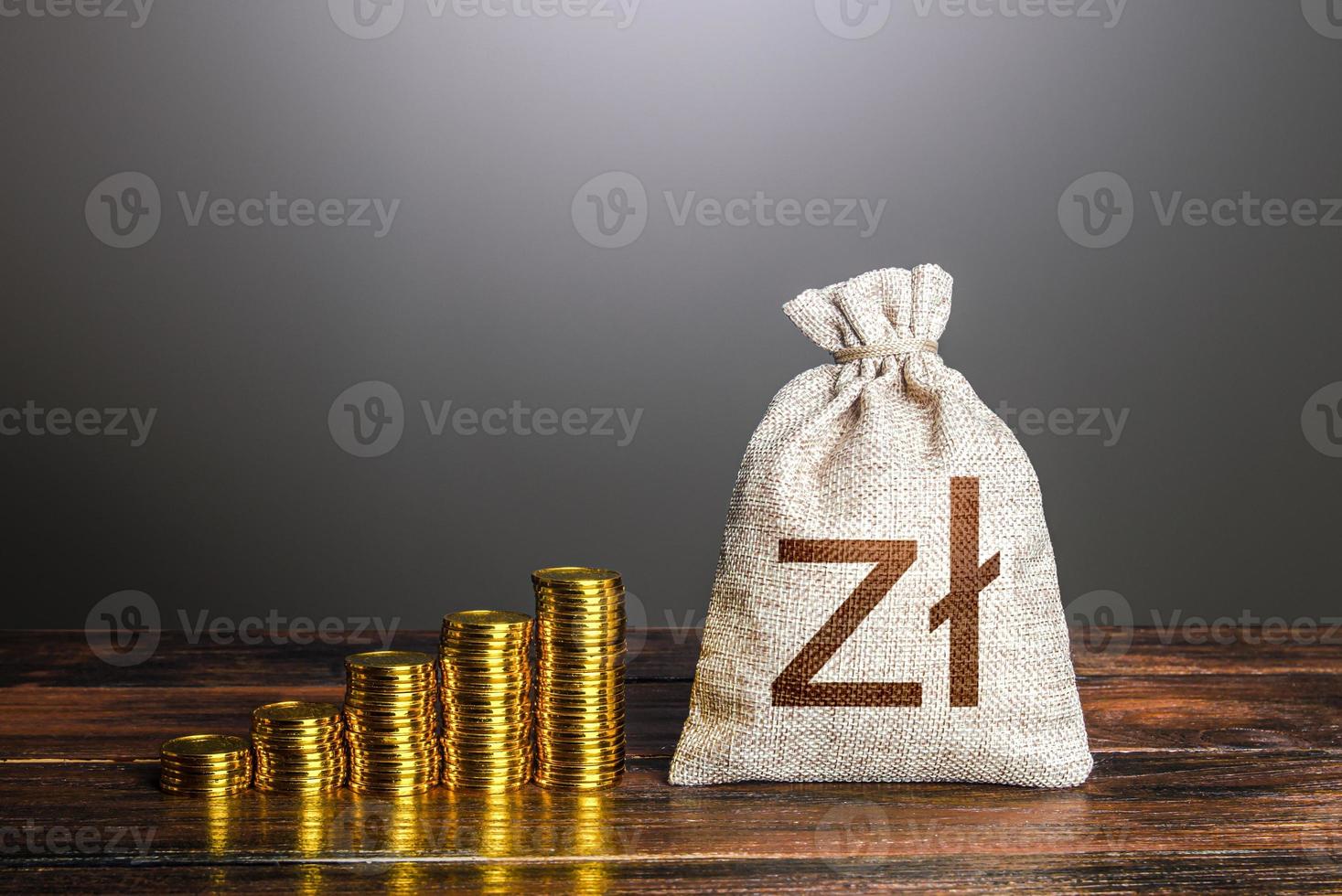 Polish zloty money bag and increasing stacks of coins. Savings. Rise in profits, budget fees. Investments. Financial success. Bonus. Economic growth, GDP. Raise incomes, increase salaries. photo