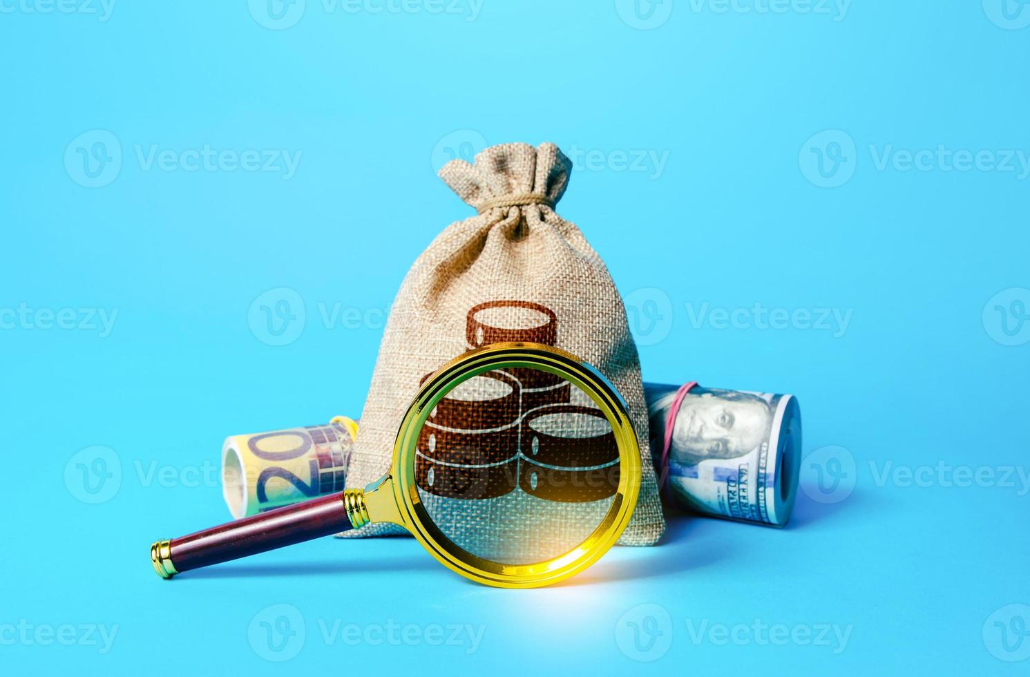 Bag with money and magnifying glass. Investigating capital origins. Deposit or loan terms and conditions. Anti money laundering, tax evasion. Find investment funds for business project. photo
