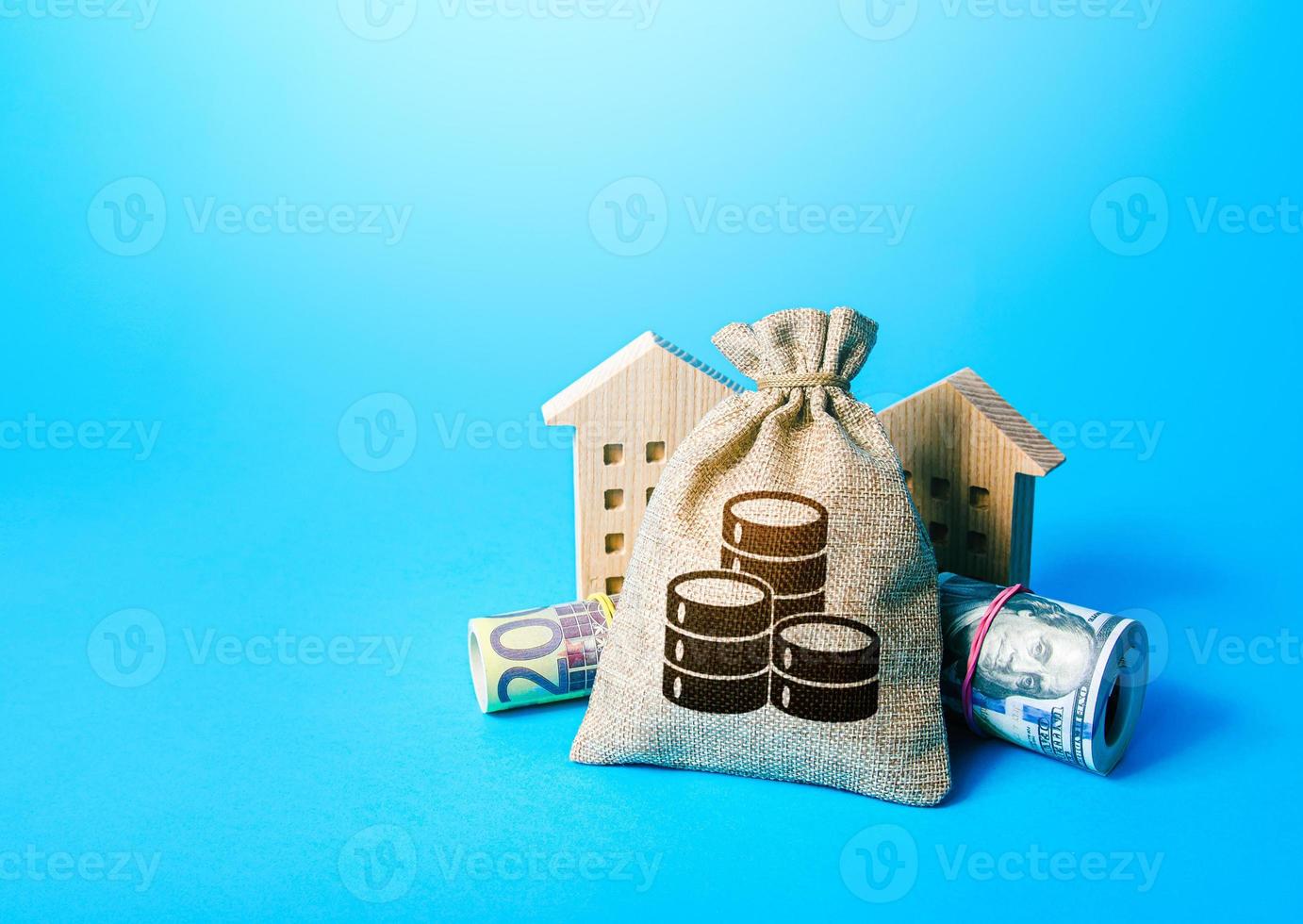 Money bag and houses. Asset, financial resource management. Real estate. Savings. Declaration, taxes payment. Bookkeeping and accounting. Building up capital, saving from inflation risks. photo