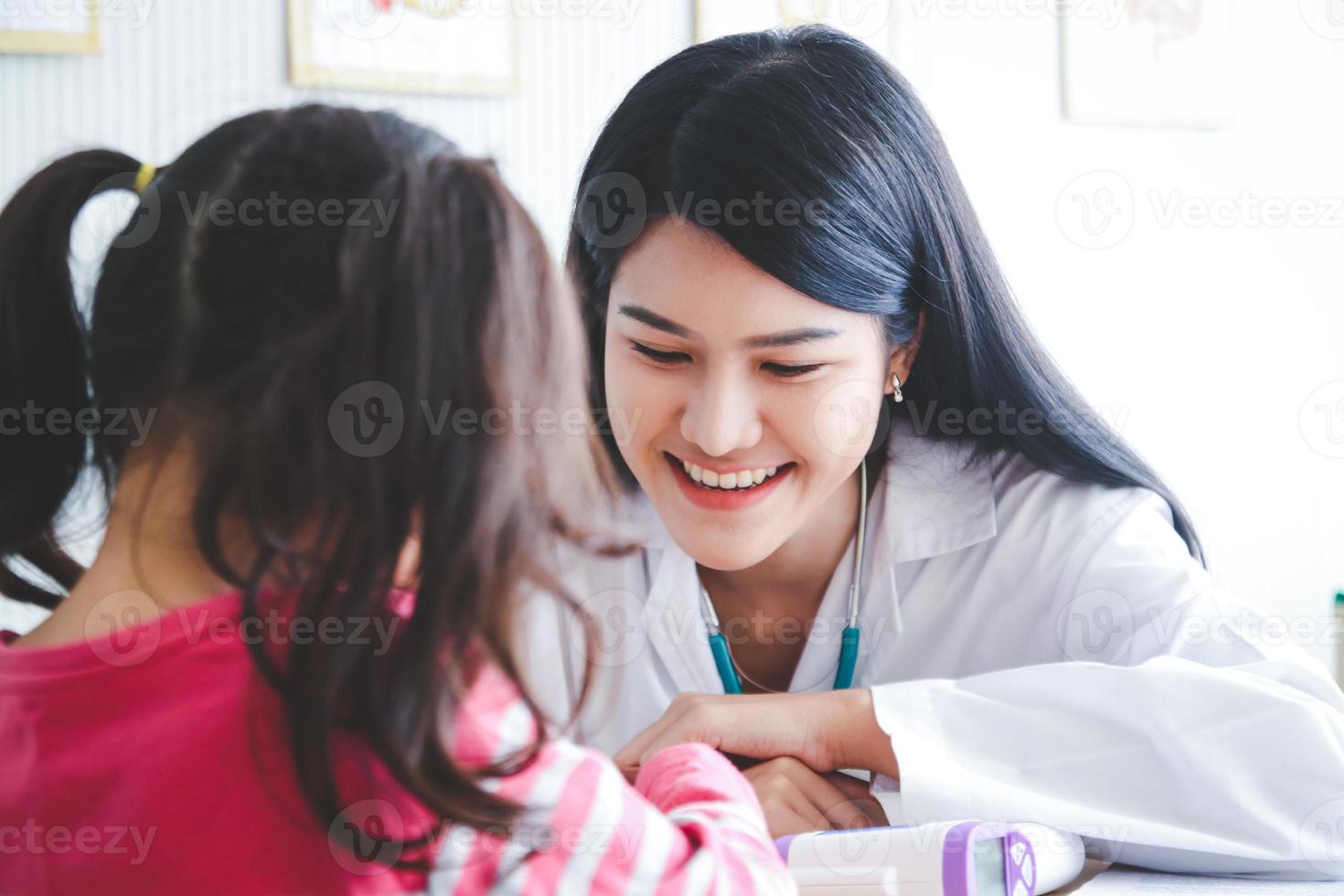 The doctor uses a stethoscope to check the rhythm, rate and consistency of the heartbeat. Listen to the sound of the heart saying there is an abnormal sound or not. Of a little girl photo