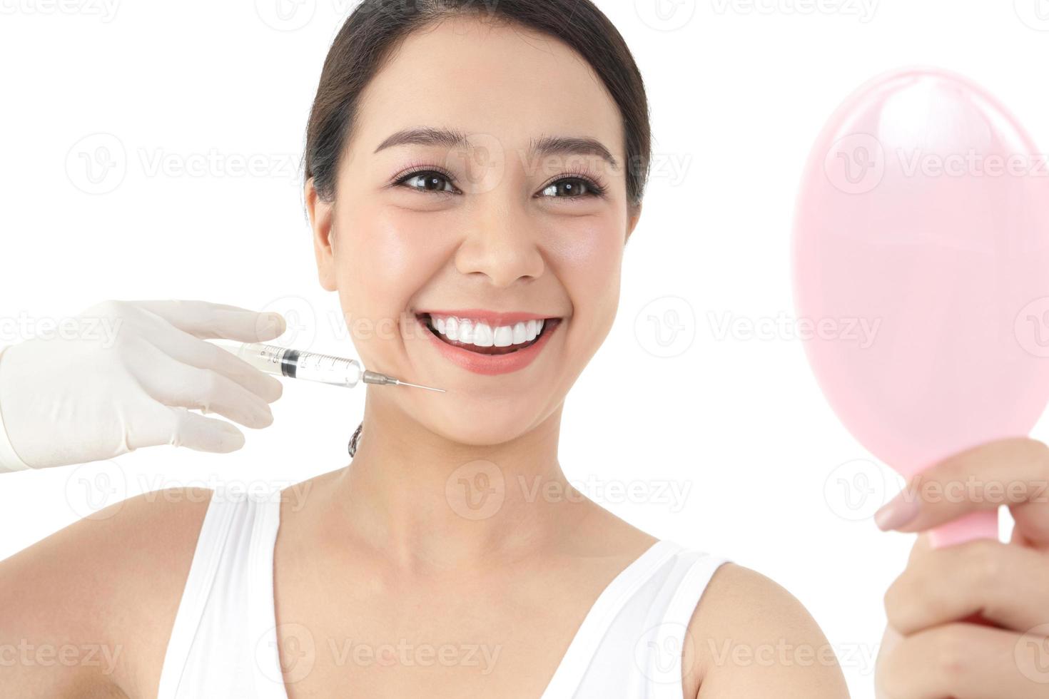 Beautiful Asian woman has a doctor to inject the face to treat acne. Skin care beauty concept. White background photo