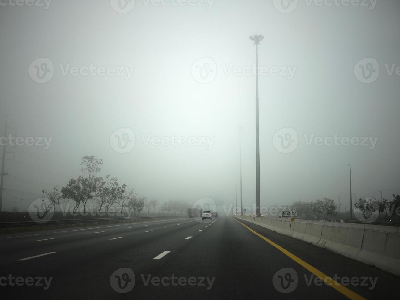 Road in the fog, sign mention keep distance for Motorway-t7.svg photo