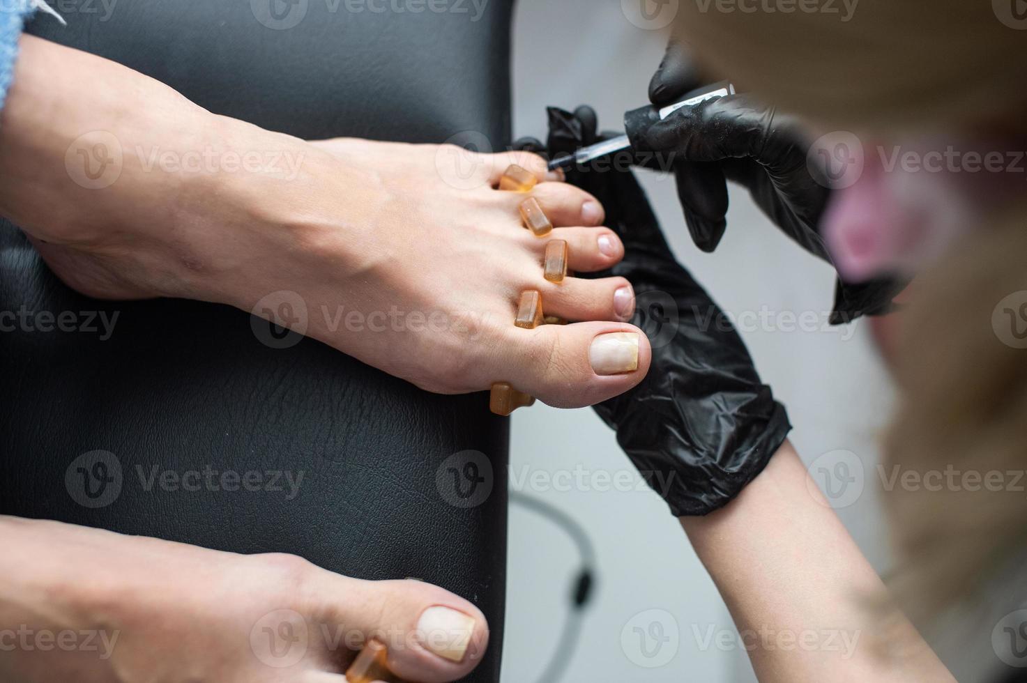 Beautiful salon procedure with pink pedicure on towel background. For decoration design photo