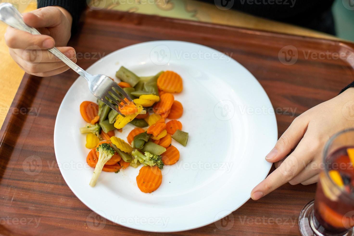 Healthy healthy food on a tray in a plate. Eat vegetables with a fork photo