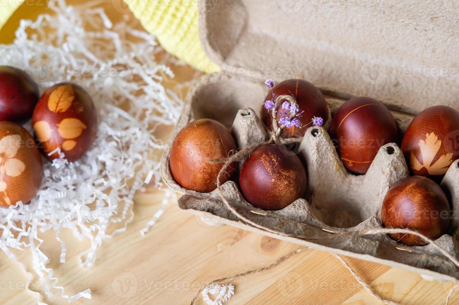 Painted eggs cooked for Easter are in an eco-friendly tray on the table photo