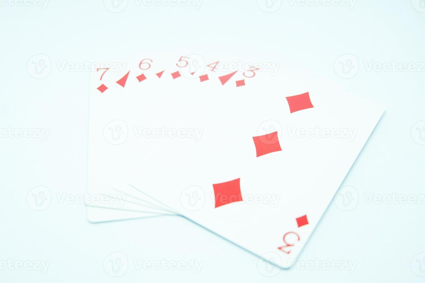A straight flush hand in poker consisting of the three, four, five, six, and seven of diamonds photo