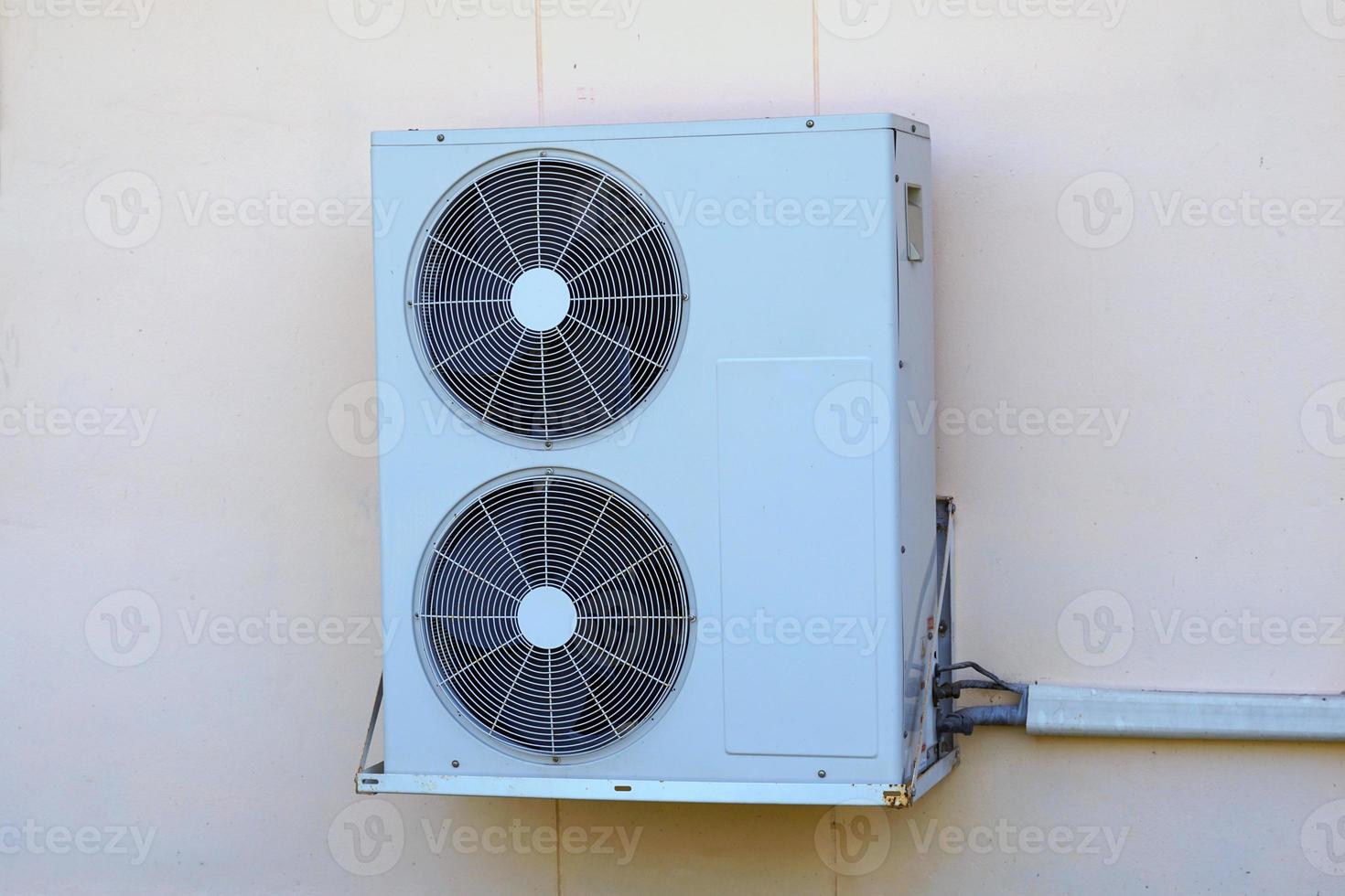 home air conditioner coil or condenser with 2 blades with motor installed outside the building perform cooling function There are two types of cooling mediums are air cooled and water cooled. photo