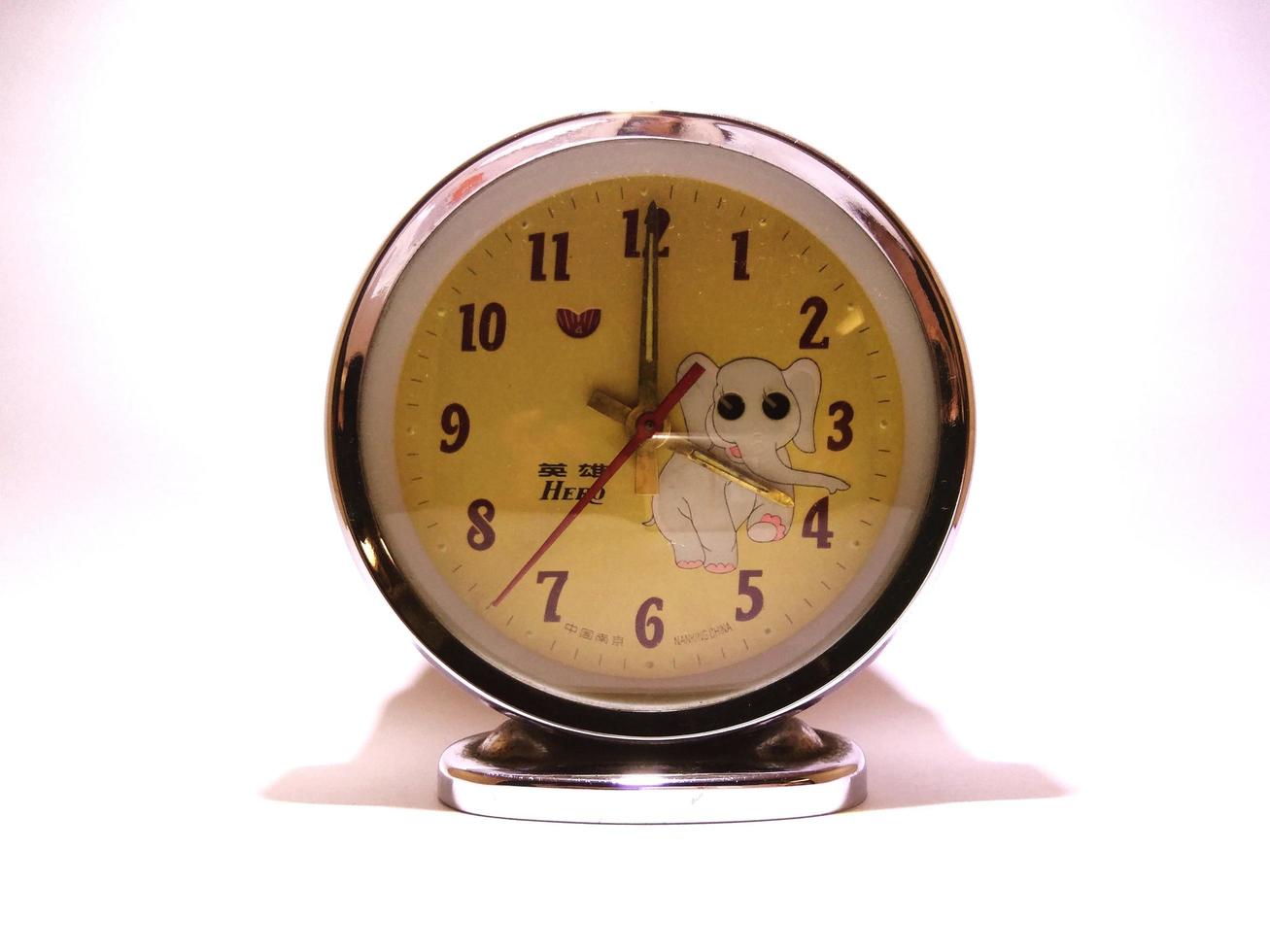 Antique classic alarm clock running manually with winding movement. photo