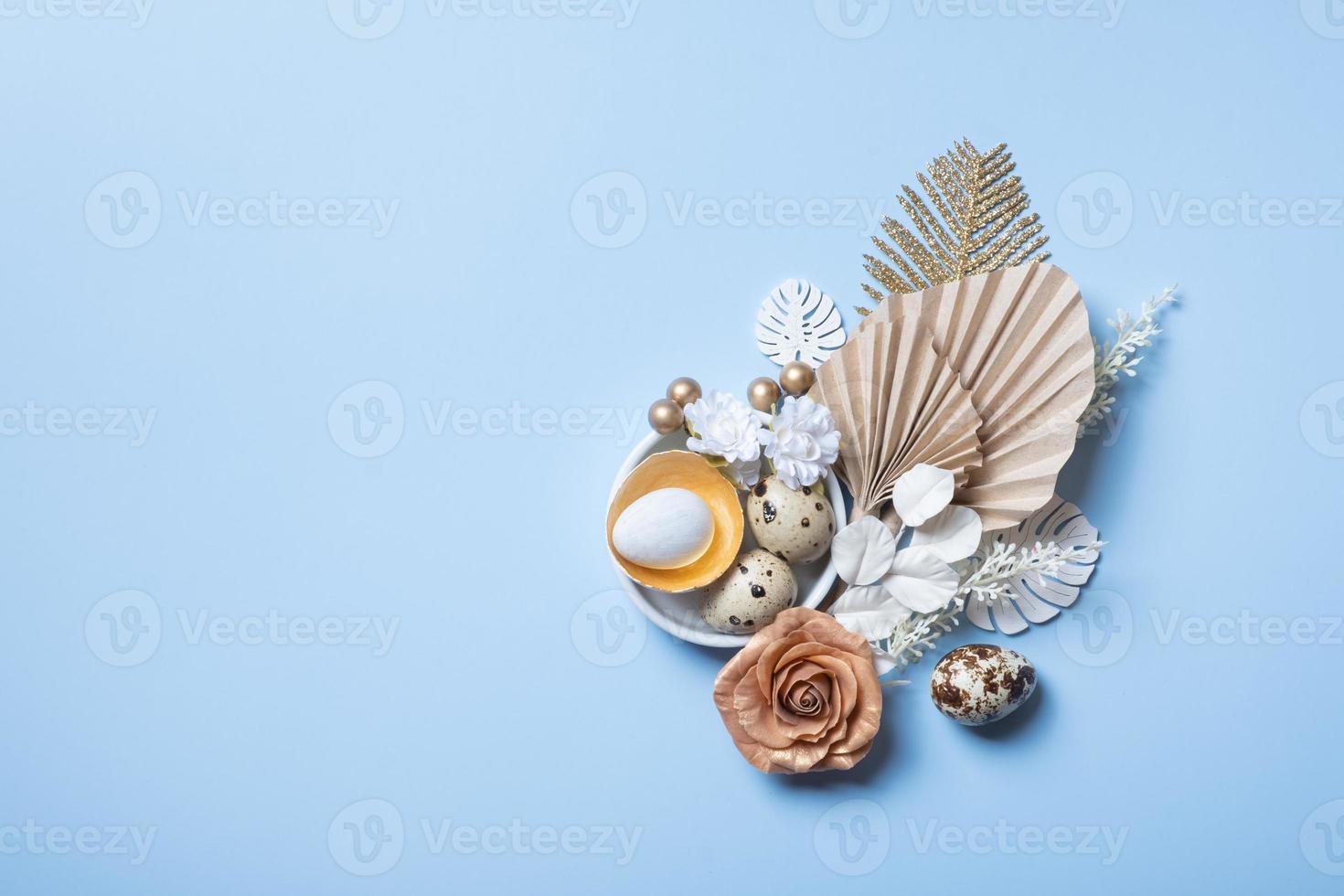 Modern creative composition with easter eggs, palm leaves and flowers top view. Easter flat lay photo