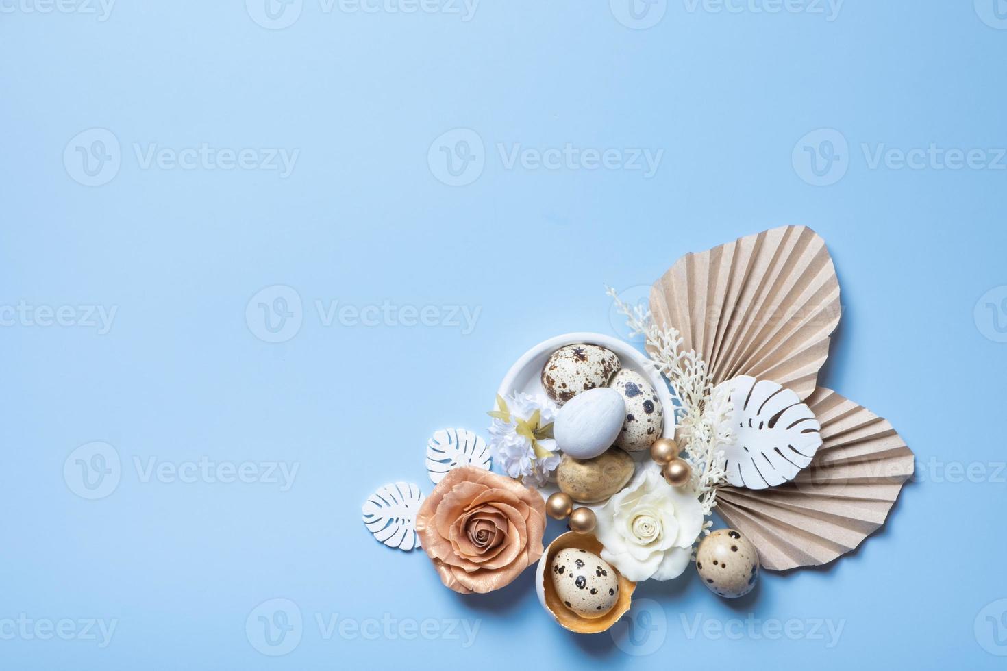 Modern creative composition with easter eggs, palm and monstera leaves and flowers top view. Easter flat lay photo