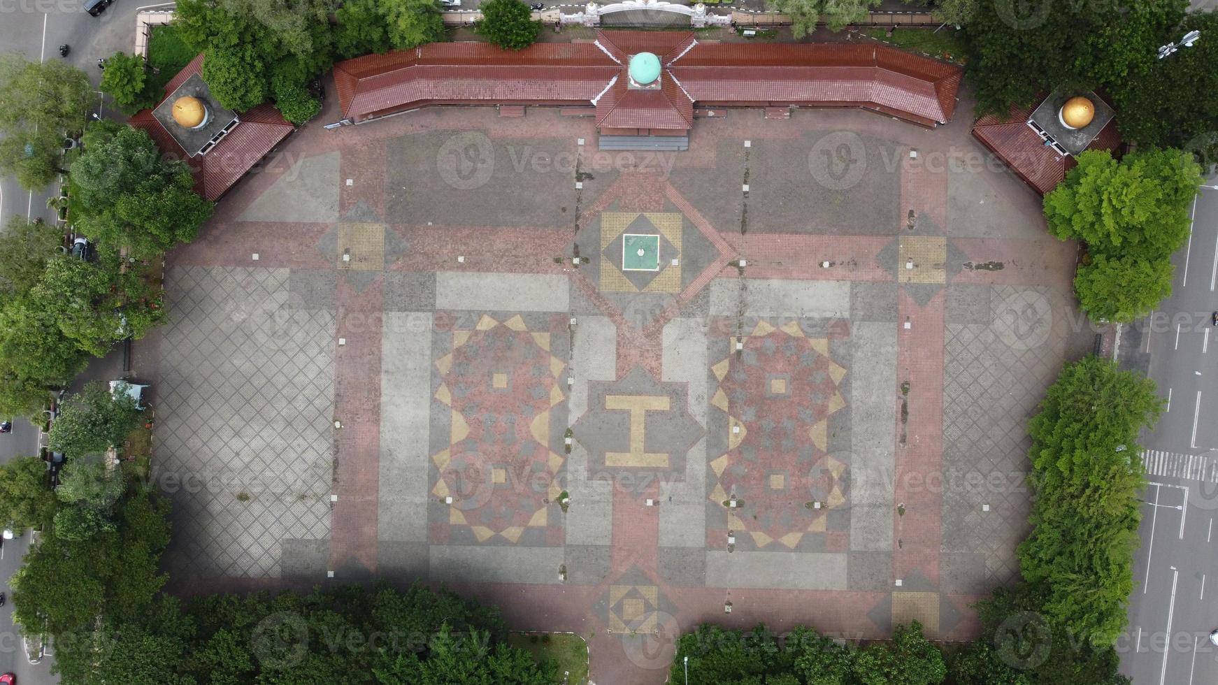 A view of the beautiful field in the middle of the city square by drone, this field is for ceremonies, sports, music concerts, special markets or other events photo